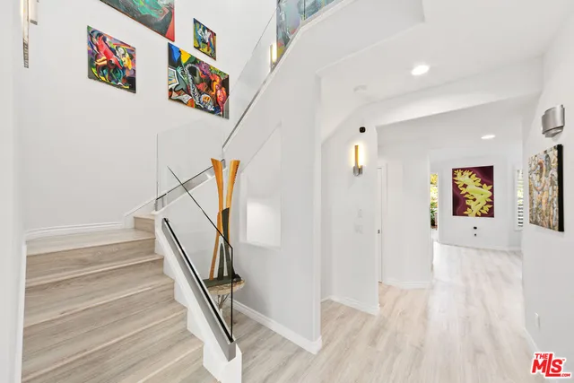 a view of a hallway with painting on the wall