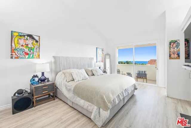 a spacious bedroom with a bed and a couch