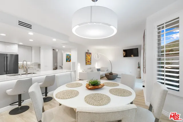 a dining room with furniture and window