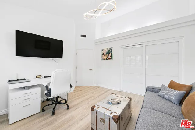 a view of a livingroom with workspace and a couch