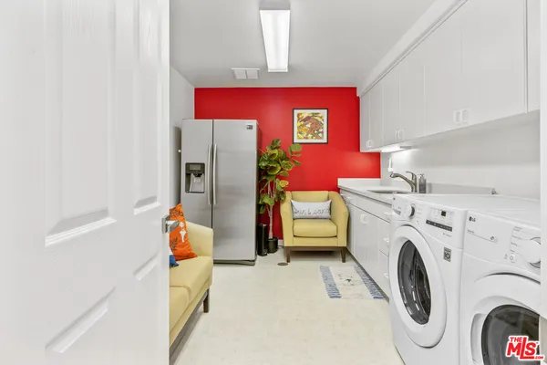 a view of storage and utility room with washer and dryer