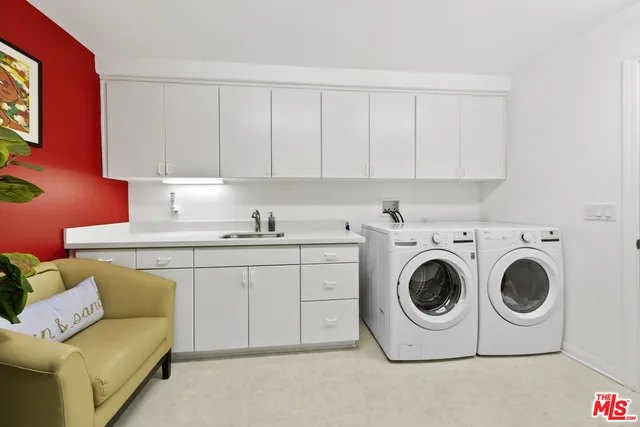 a utility room with sink dryer and washer
