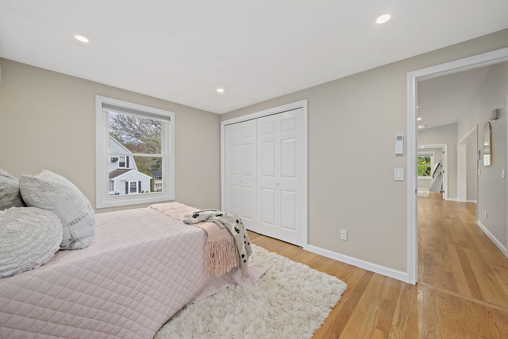 68 Dothan Street Arlington, MA 02474 - Photo 19 of 36 a bedroom with a large bed and wooden floor