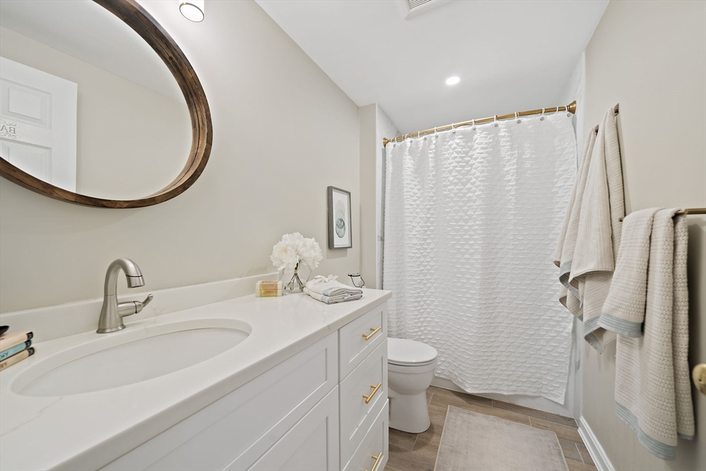 68 Dothan Street Arlington, MA 02474 - Photo 22 of 36 a bathroom with a sink a toilet and a mirror