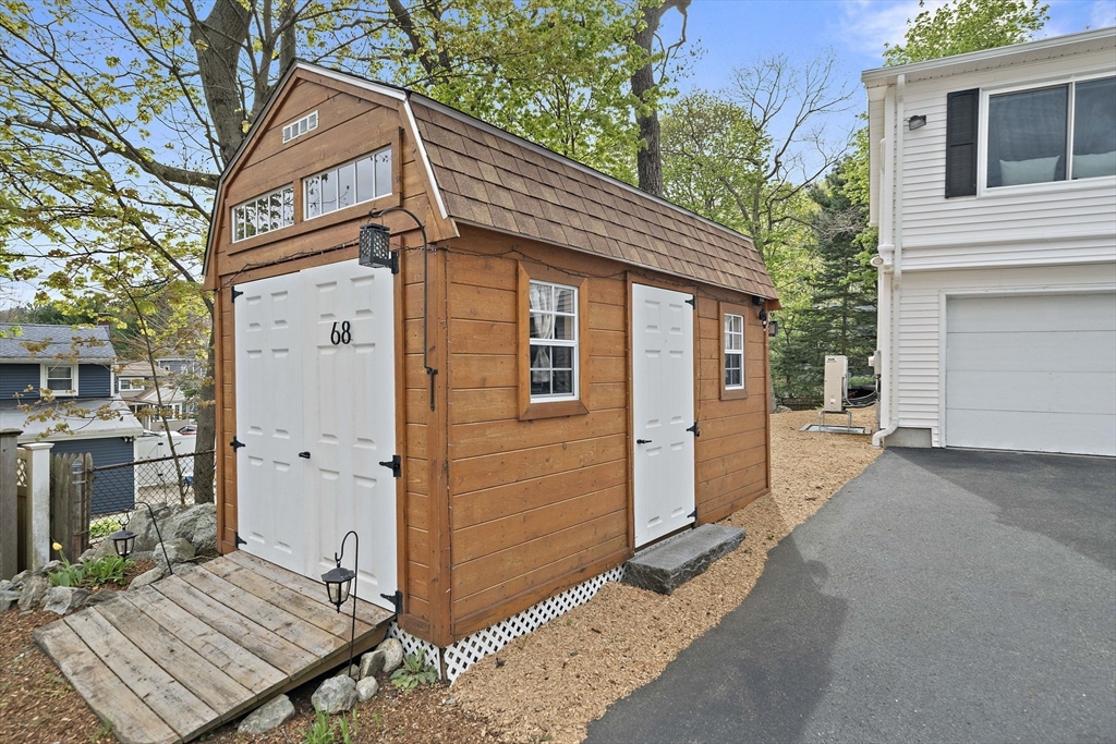 68 Dothan Street Arlington, MA 02474 - Photo 32 of 36 a view of a house with a yard and wooden fence