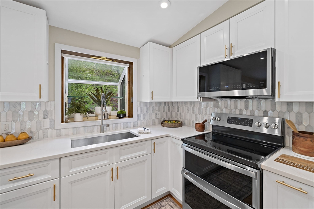 68 Dothan Street Arlington, MA 02474 - Photo 9 of 36 a kitchen with appliances a sink and a microwave