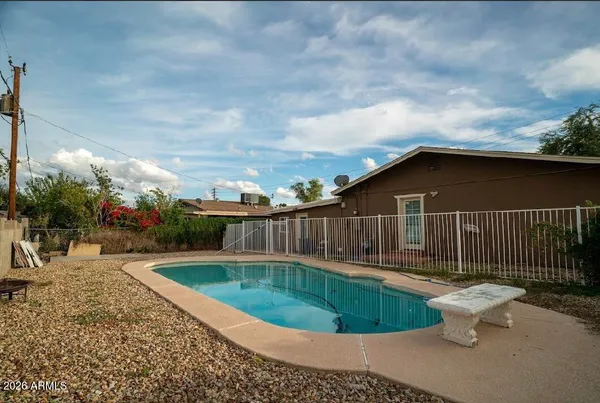 a backyard of a house with table and chairs