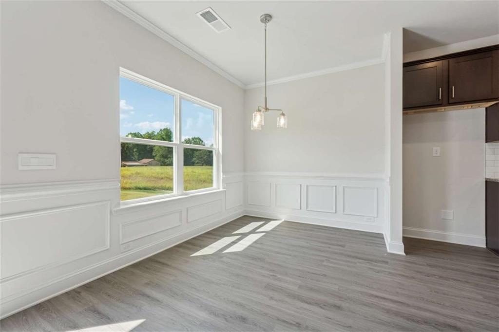 263 Eason Street Bowdon, GA 30108 - Photo 4 of 11 a view of an empty room with a window and wooden floor