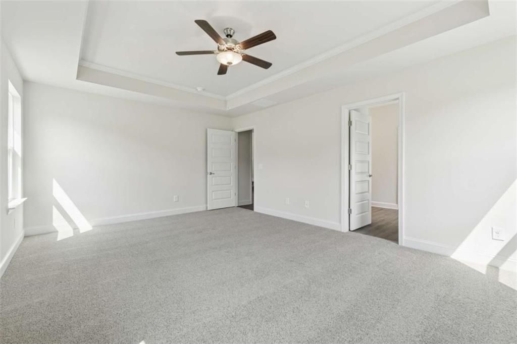 263 Eason Street Bowdon, GA 30108 - Photo 8 of 11 an empty room with ceiling fan and window