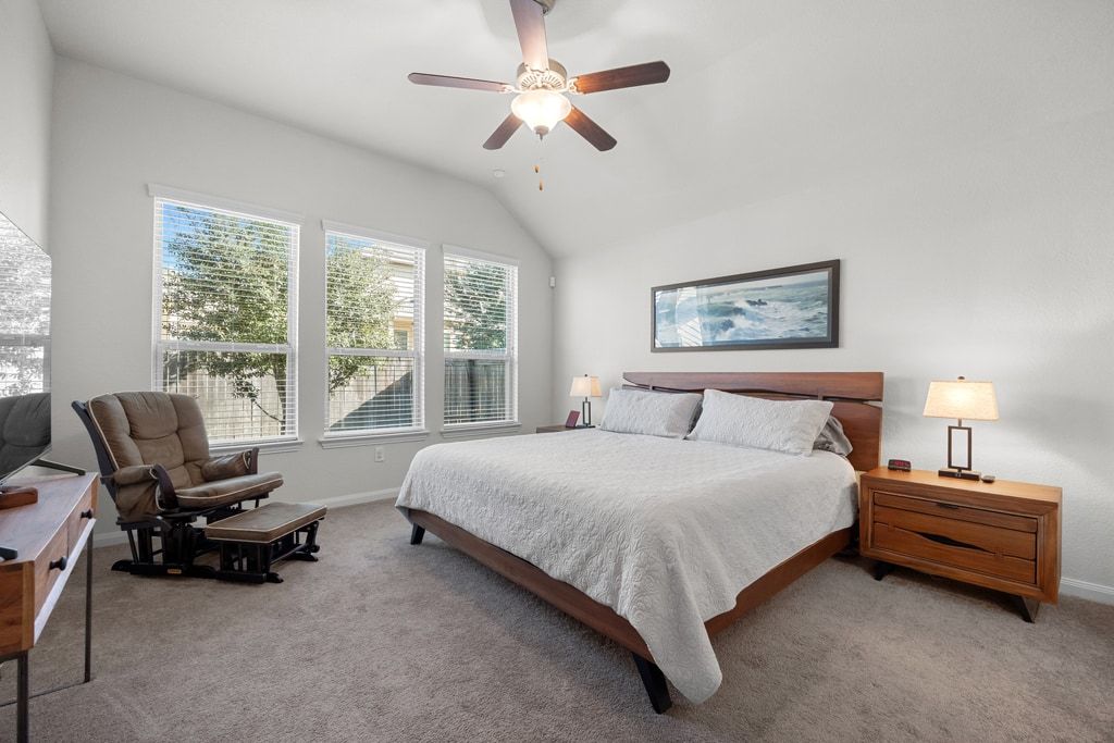 606 Linares Lane Austin, TX 78748 - Photo 11 of 35 Carpeted bedroom with a ceiling fan and vaulted ceiling