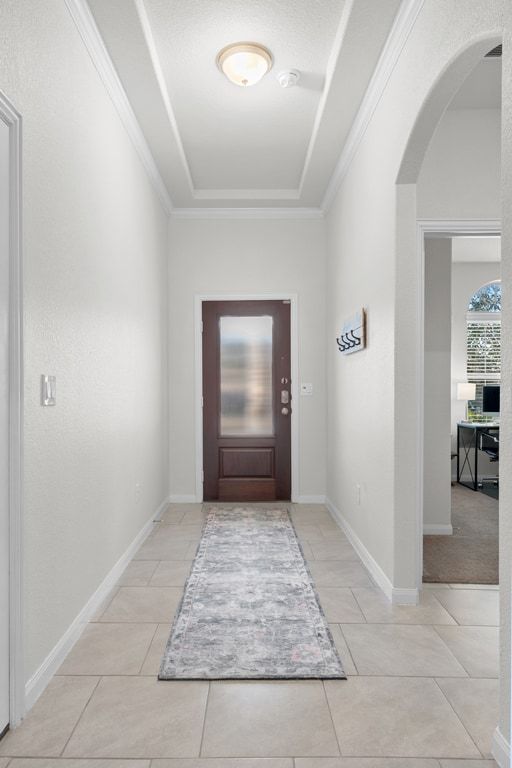 606 Linares Lane Austin, TX 78748 - Photo 23 of 35 Entryway with arched walkways, a raised ceiling, and ornamental molding