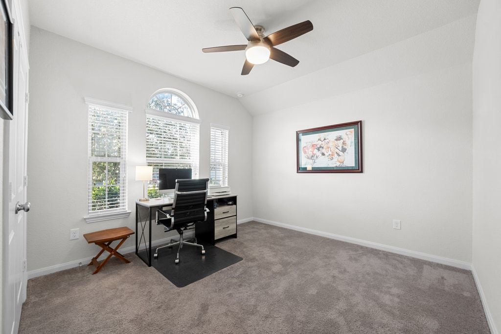 606 Linares Lane Austin, TX 78748 - Photo 24 of 35 Home office featuring light carpet, ceiling fan, and vaulted ceiling