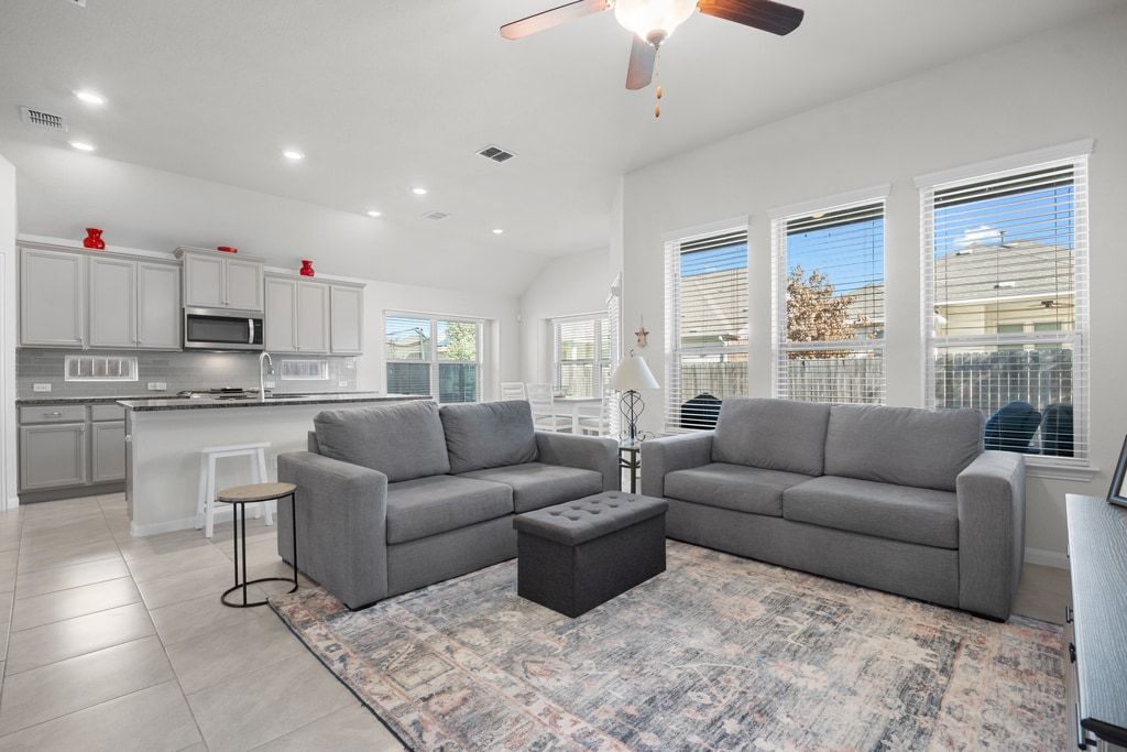 606 Linares Lane Austin, TX 78748 - Photo 3 of 34 a living room with furniture and a large window