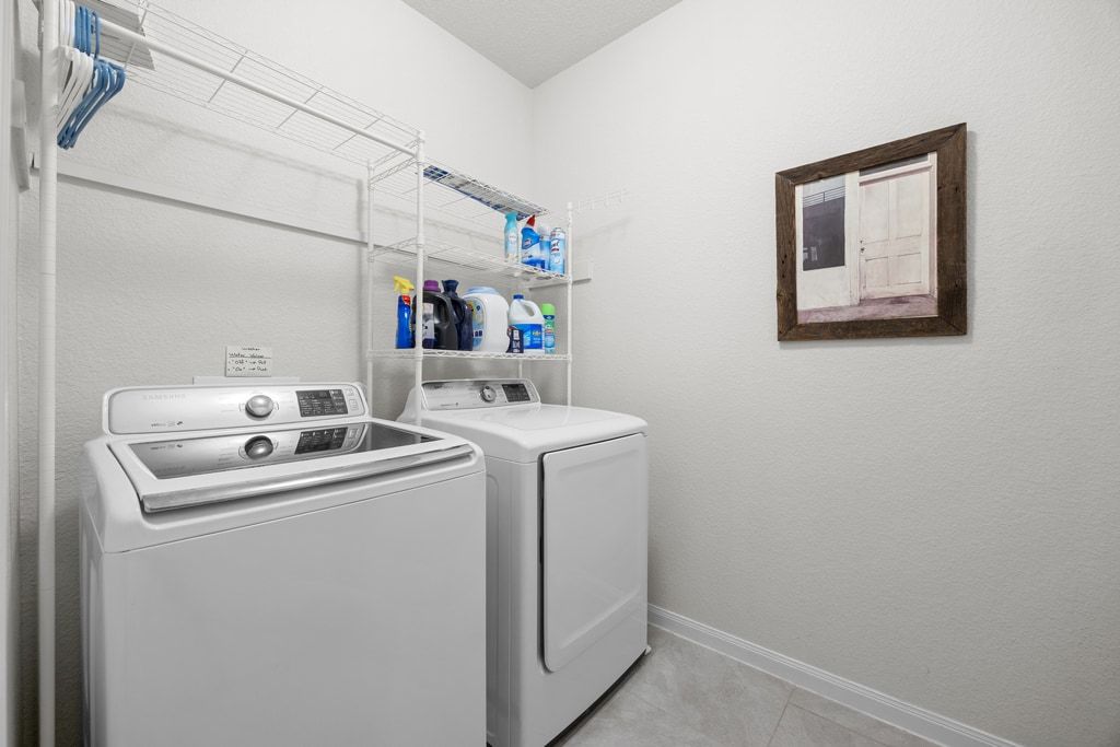 606 Linares Lane Austin, TX 78748 - Photo 29 of 35 Washroom featuring baseboards and washer and dryer