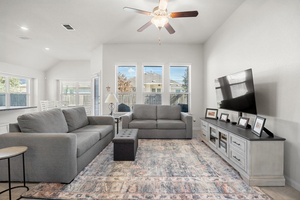 606 Linares Lane Austin, TX 78748 - Photo 7 of 35 Living area with a ceiling fan, vaulted ceiling, and recessed lighting