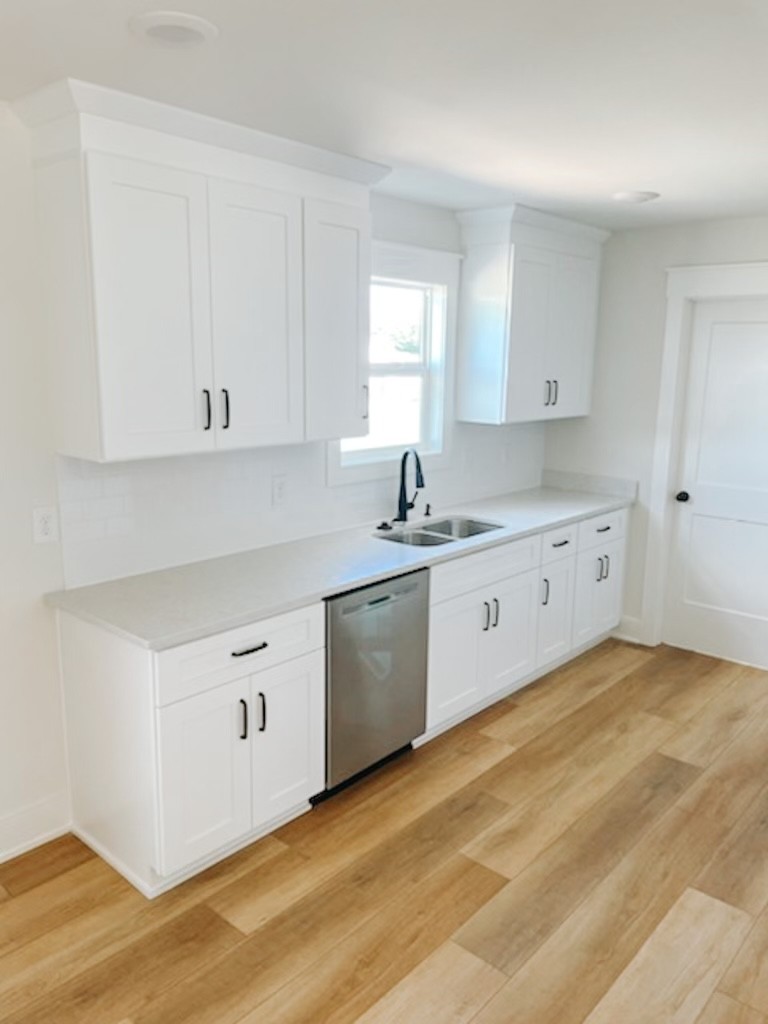 243 Tom Ferrell Road Portland, TN 37148 - Photo 10 of 17 a kitchen with white cabinets and white appliances