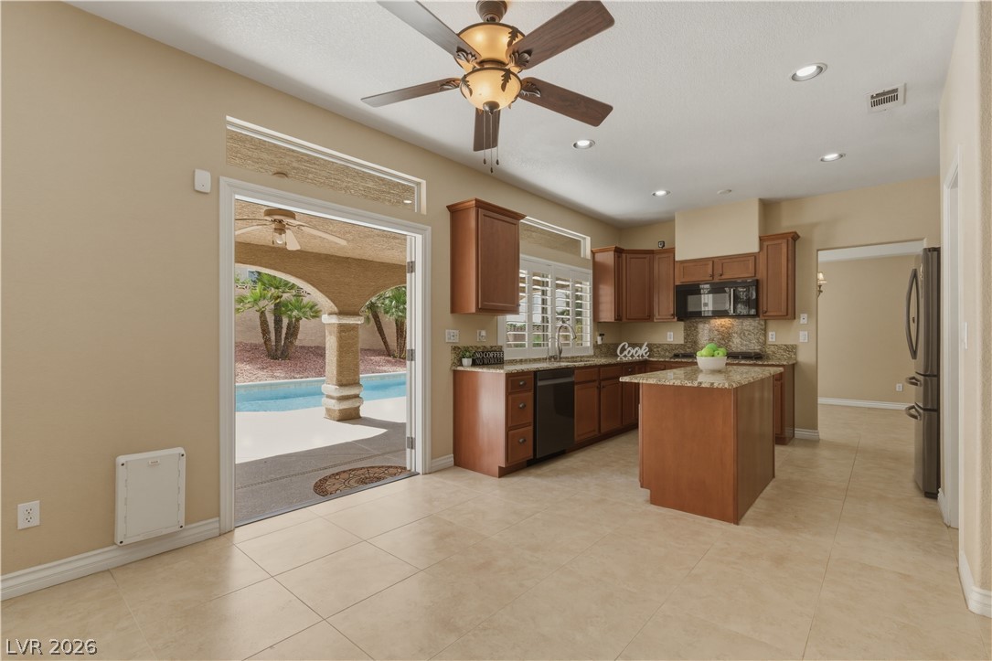 29 Olive Tree Henderson, NV 89074 - Photo 13 of 60 This spacious kitchen with pool access offers effortless indoor-outdoor living and dining.