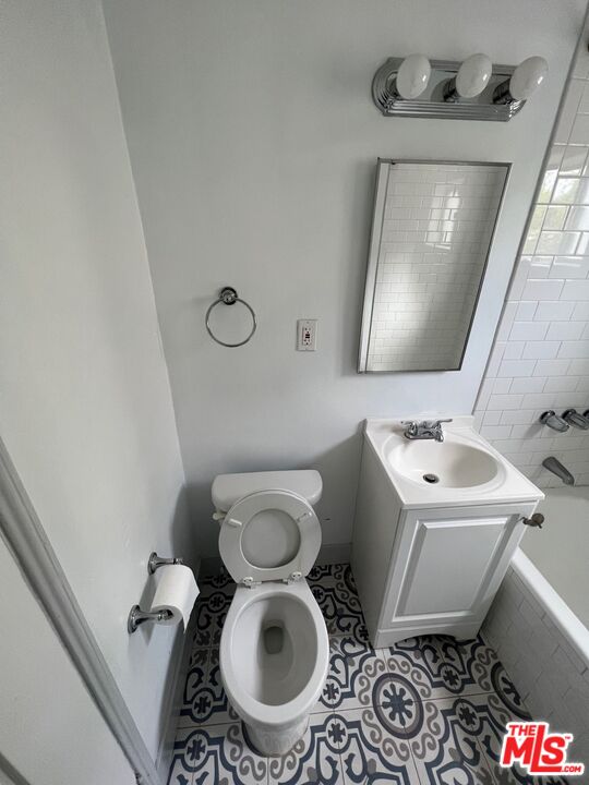 1217 Cedar Avenue Long Beach, CA 90813 - Photo 8 of 15 a bathroom with a toilet sink and mirror
