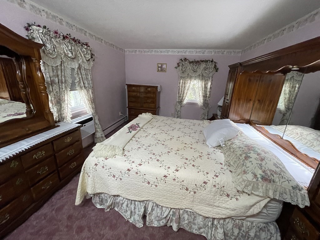 90 Colonial Circle, Unit A Chicopee, MA 01020 - Photo 13 of 17 a bed sitting in a bedroom next to a window