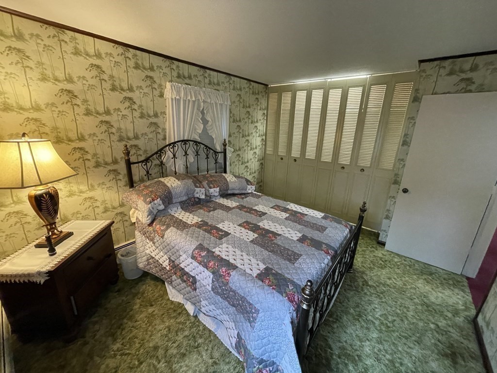 90 Colonial Circle, Unit A Chicopee, MA 01020 - Photo 15 of 17 a bed sitting in a bedroom next to a window