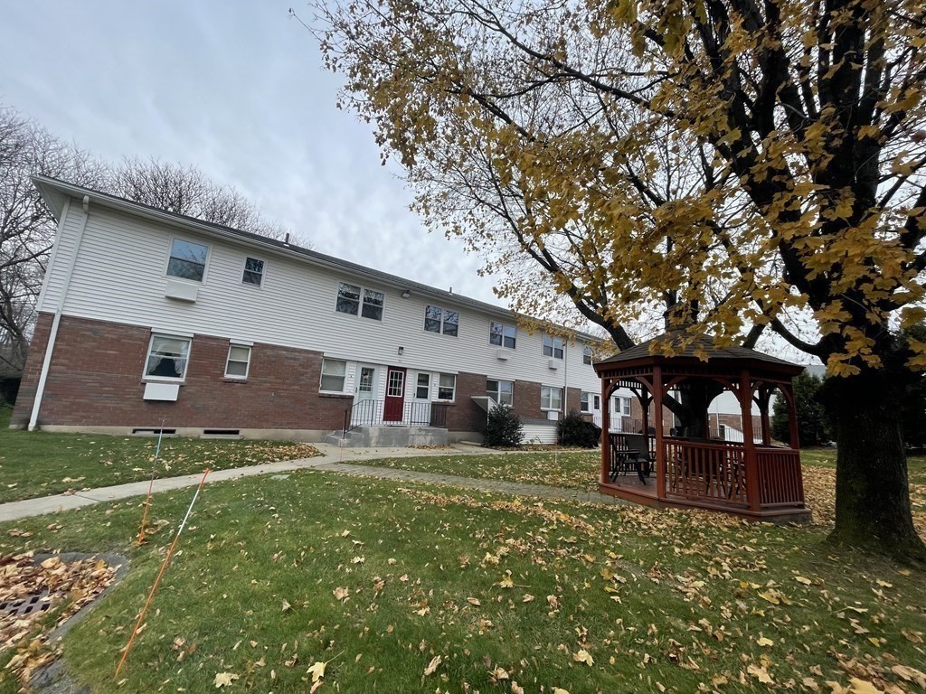 90 Colonial Circle, Unit A Chicopee, MA 01020 - Photo 2 of 17 a front view of a house with garden