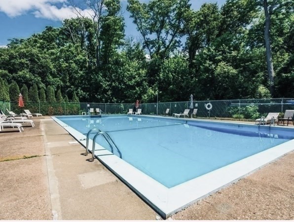 90 Colonial Circle, Unit A Chicopee, MA 01020 - Photo 4 of 17 a view of a swimming pool with a patio