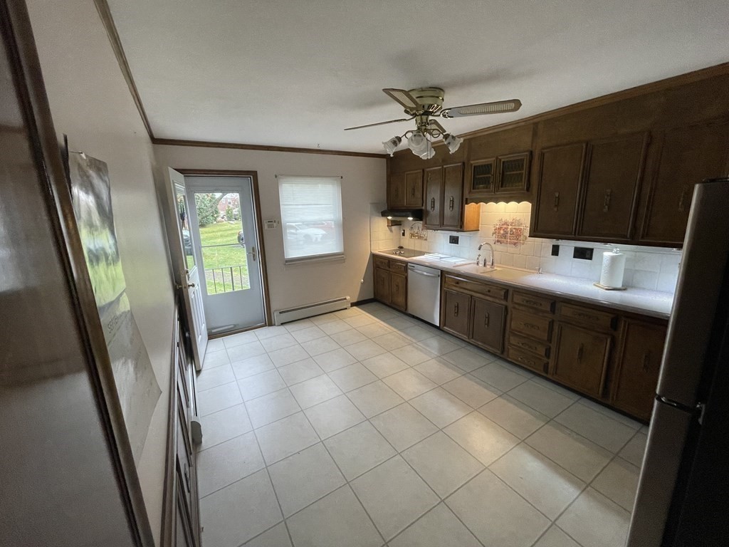 90 Colonial Circle, Unit A Chicopee, MA 01020 - Photo 5 of 17 a large white kitchen with a sink a window and stainless steel appliances