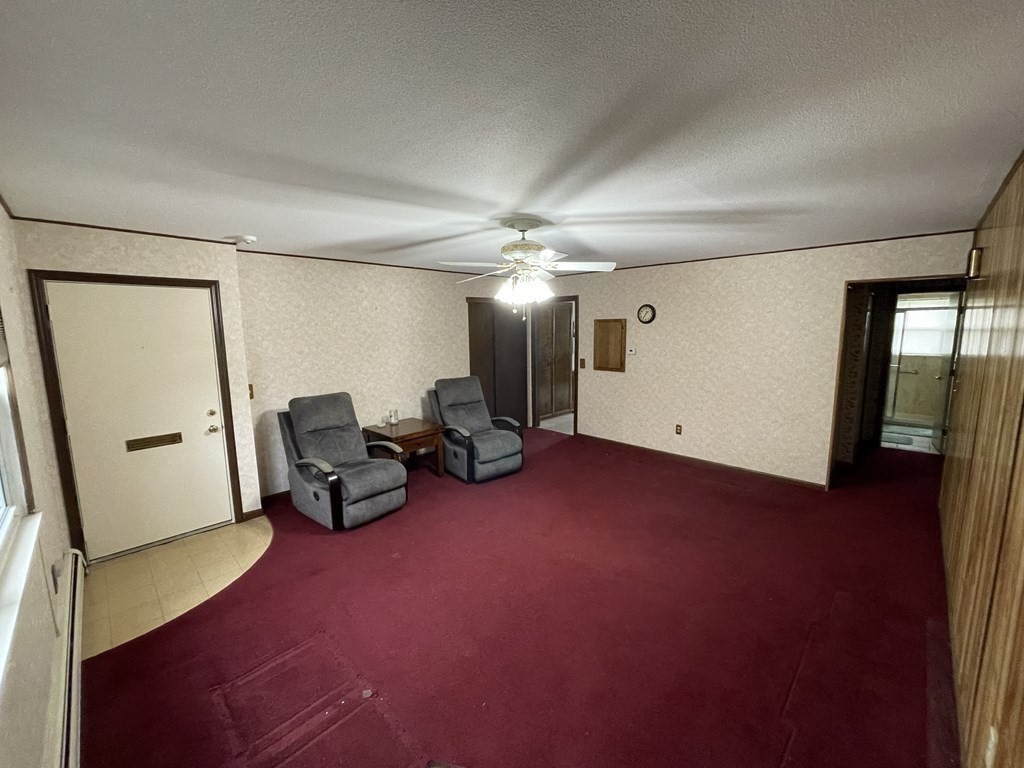 90 Colonial Circle, Unit A Chicopee, MA 01020 - Photo 7 of 17 a view of a livingroom with furniture and a ceiling fan