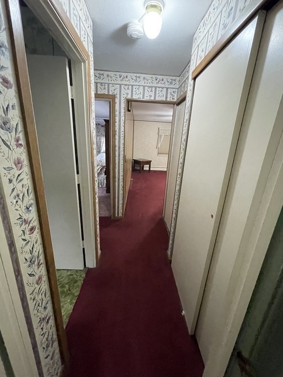 90 Colonial Circle, Unit A Chicopee, MA 01020 - Photo 10 of 17 a view of a hallway with wooden floor and stairs