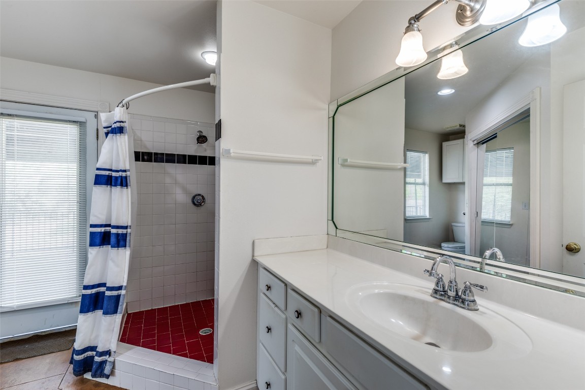 5718 McCarty Lane, Unit B Austin, TX 78749 - Photo 16 of 25 a bathroom with a sink double vanity and a mirror