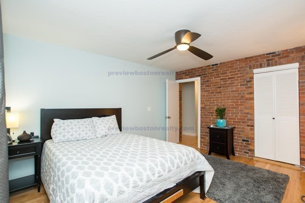 29 Brainerd Road, Unit 304 Boston, MA 02134 - Photo 15 of 22 a bedroom with a bed and a dresser