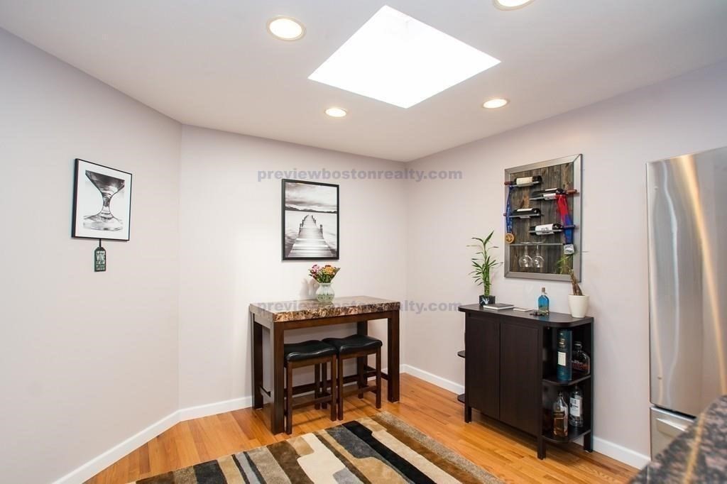29 Brainerd Road, Unit 304 Boston, MA 02134 - Photo 18 of 22 a view of a workspace with furniture and wooden floor