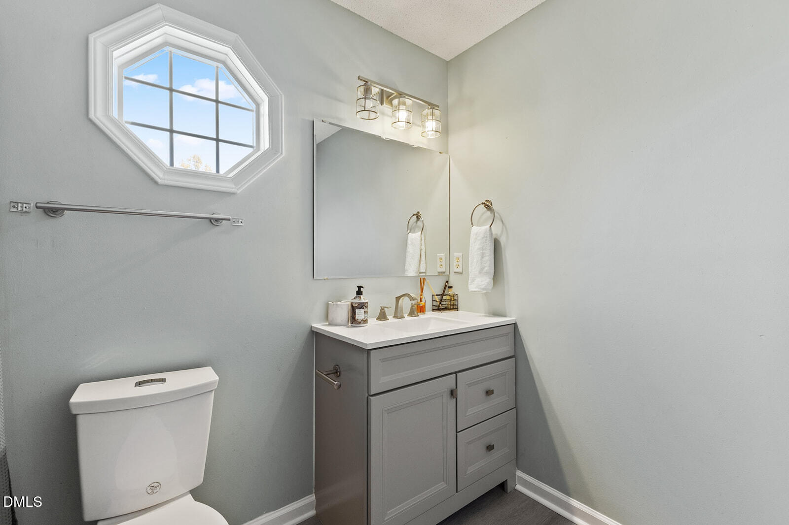 12 Byerly Court Durham, NC 27713 - Photo 19 of 28 a bathroom with a toilet sink and mirror