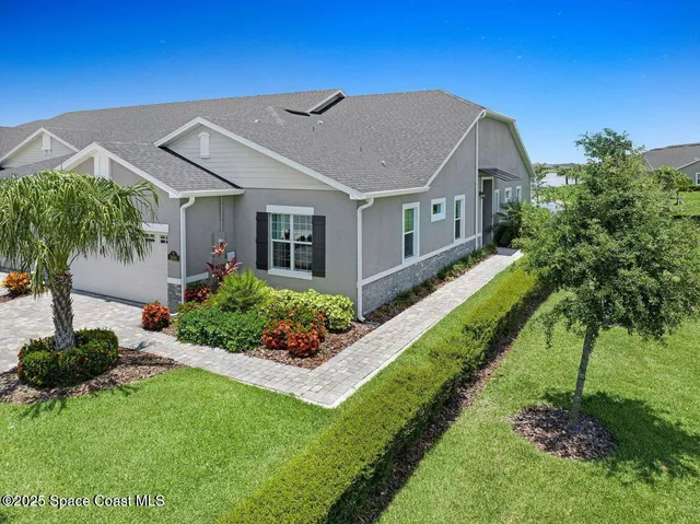 a aerial view of a house with a big yard and potted plants