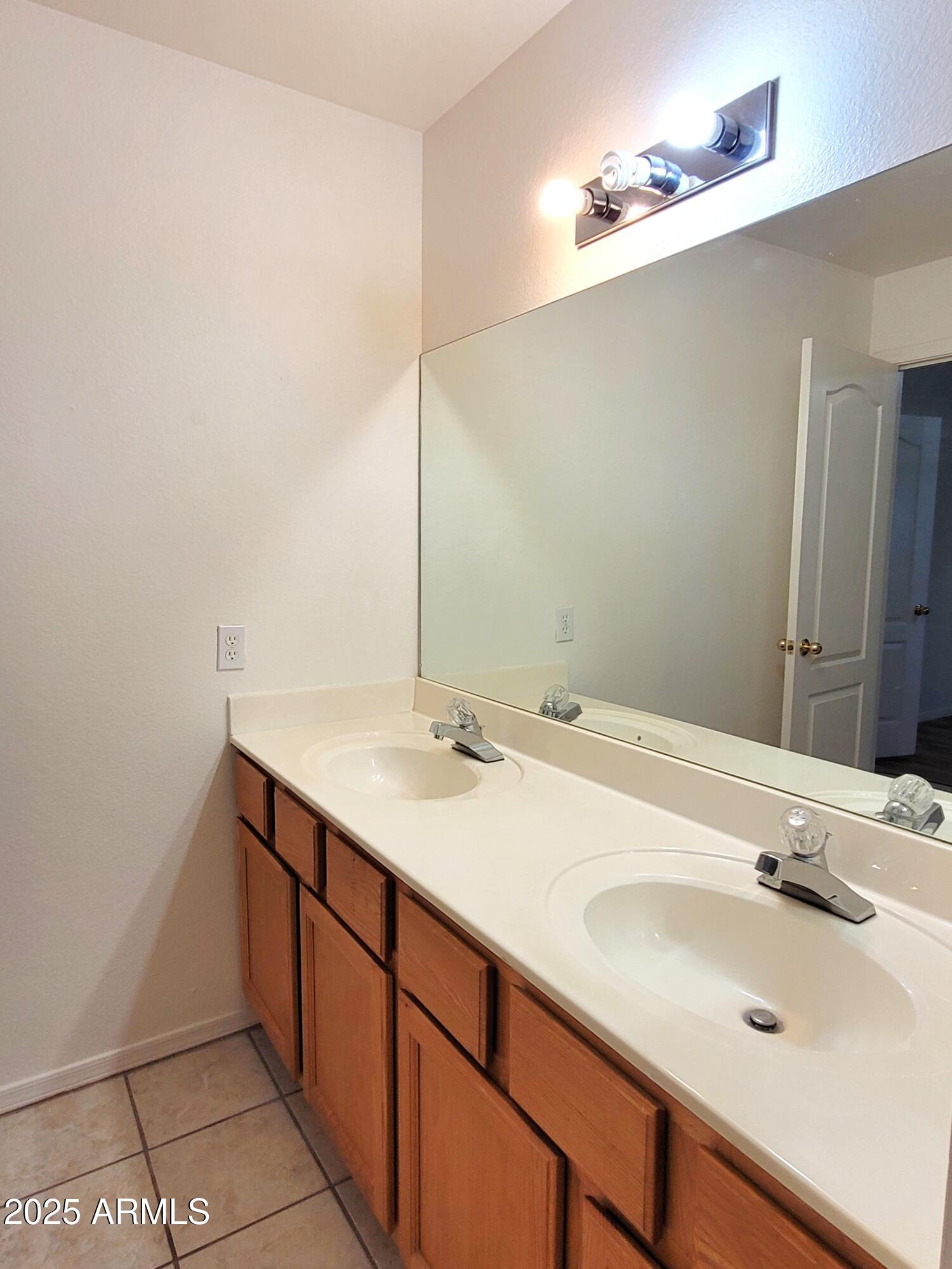9151 West Greenway Road, Unit 152 Peoria, AZ 85381 - Photo 13 of 17 a bathroom with a sink and a mirror