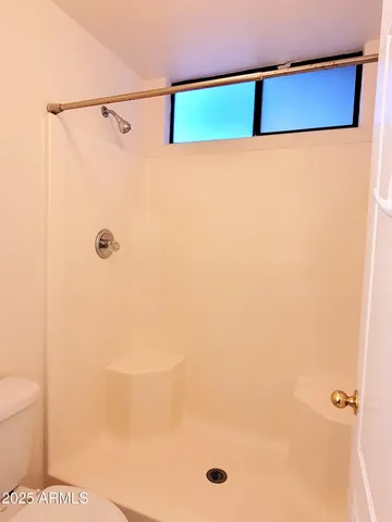 an empty room with a window and wooden floor