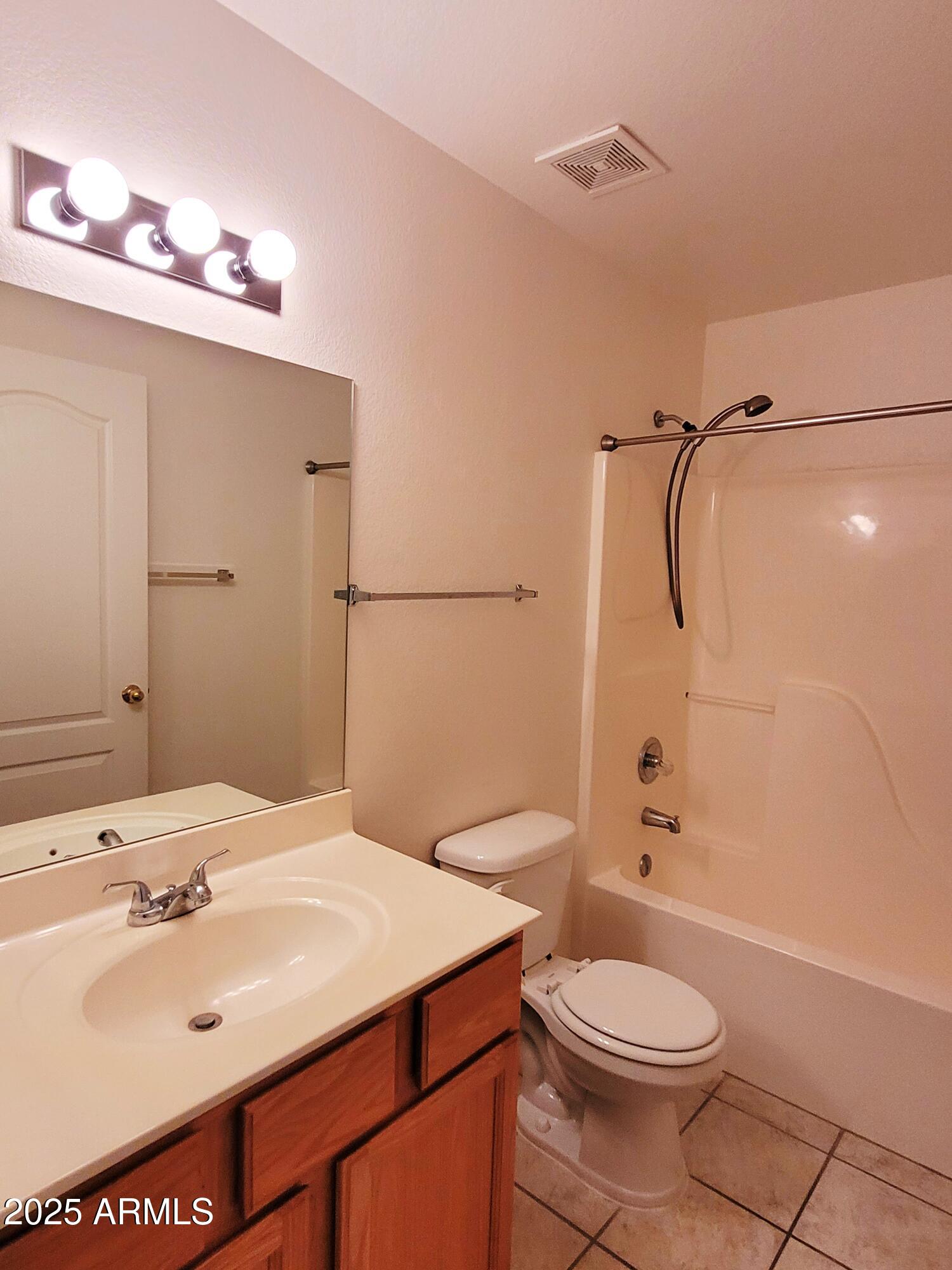 9151 West Greenway Road, Unit 152 Peoria, AZ 85381 - Photo 17 of 17 a bathroom with a sink a toilet and shower
