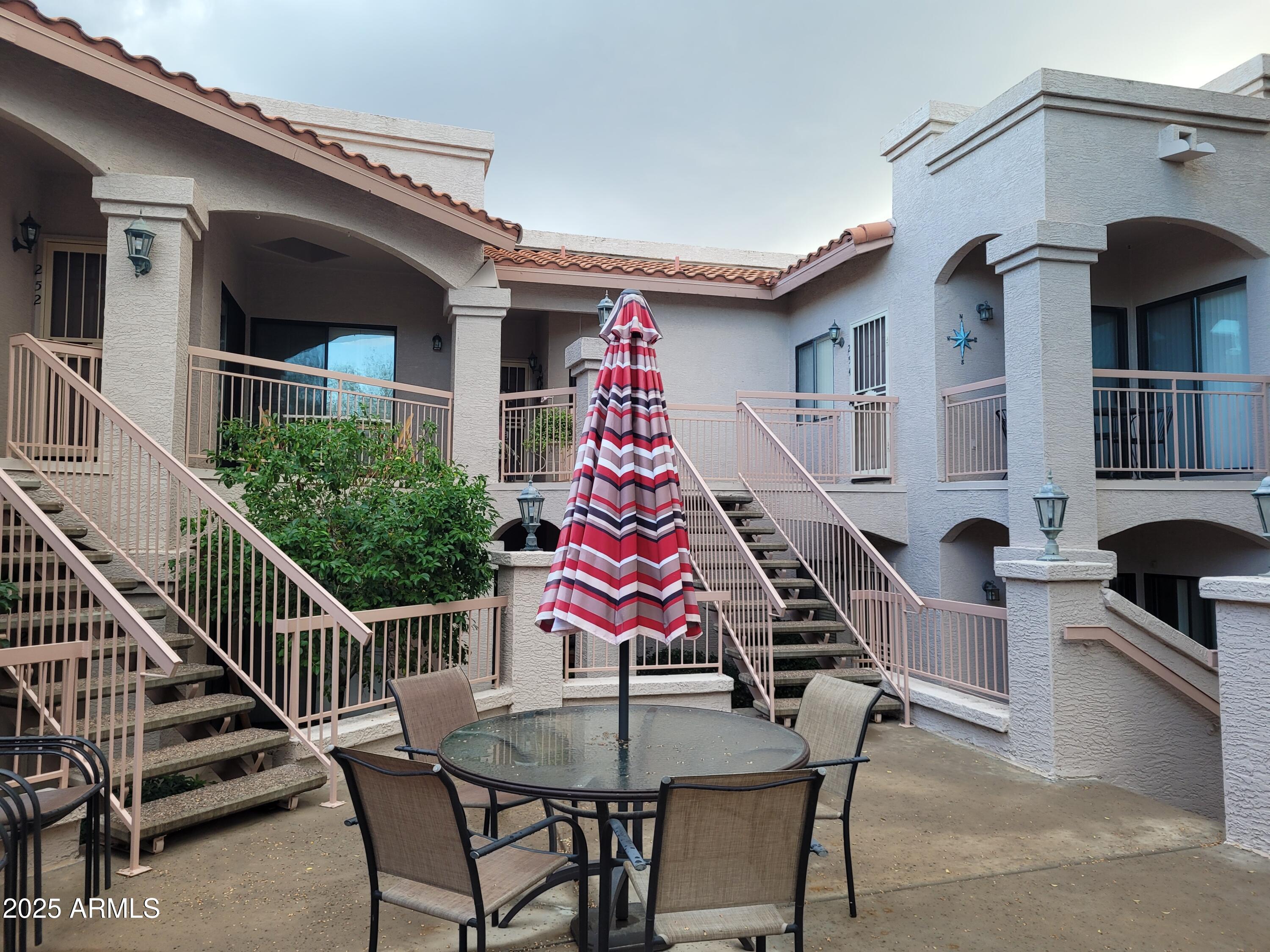 9151 West Greenway Road, Unit 152 Peoria, AZ 85381 - Photo 3 of 17 a view of a roof deck with table and chairs