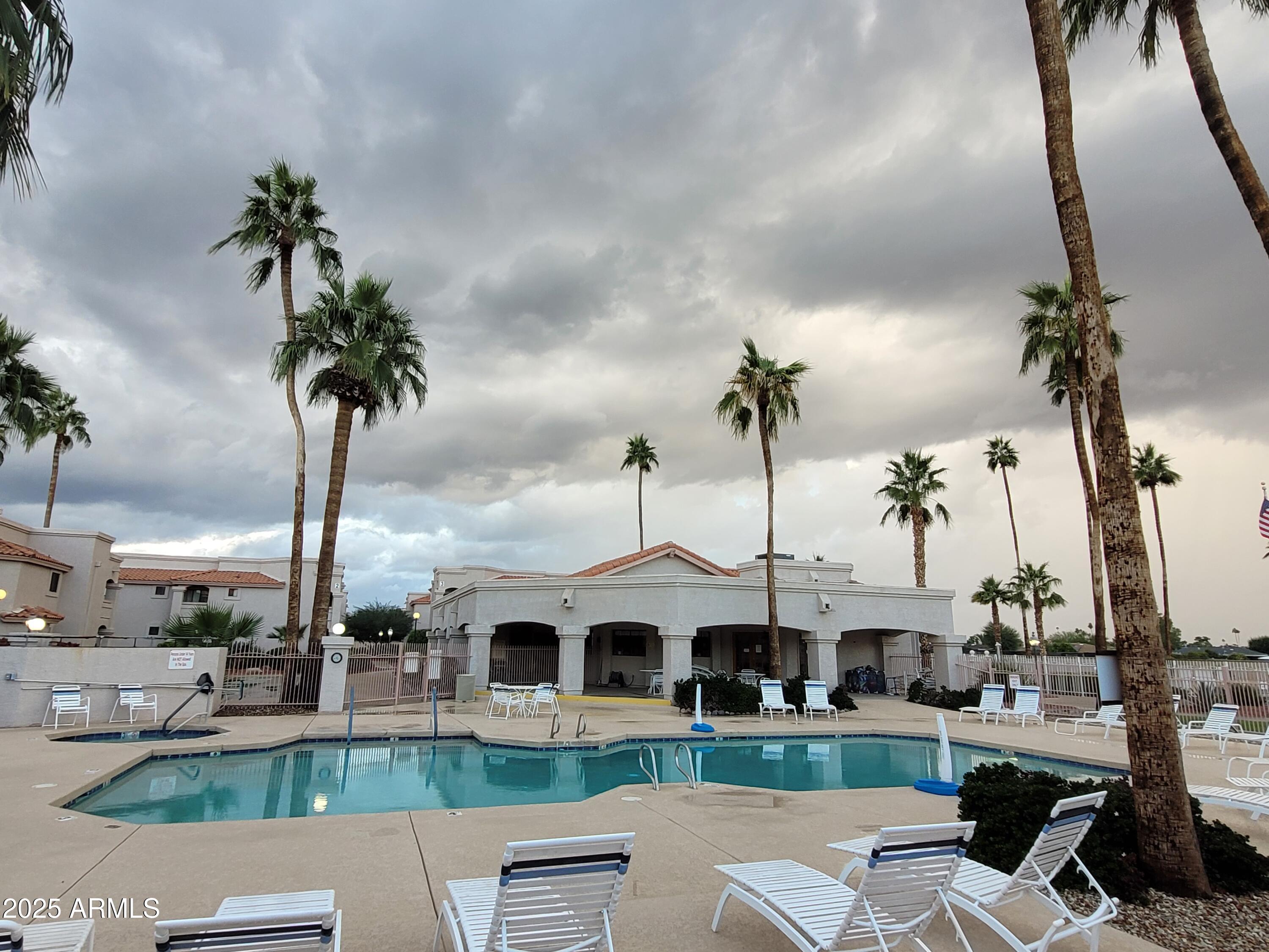 9151 West Greenway Road, Unit 152 Peoria, AZ 85381 - Photo 6 of 17 a front view of multiple houses with yard