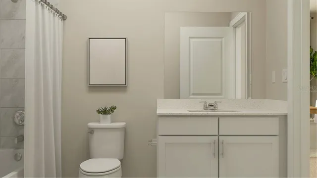 a bathroom with a sink a toilet and mirror