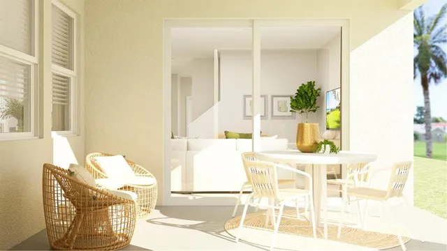 a view of a dining room with furniture and a potted plant