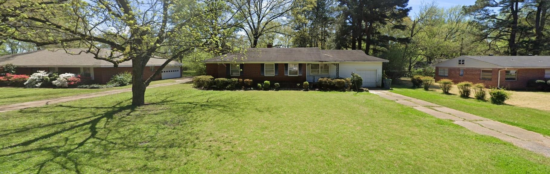 1079 Alden Road Memphis, TN 38116 - Photo 2 of 14 Ranch-style residence featuring a brick facade, attached garage, and a long driveway