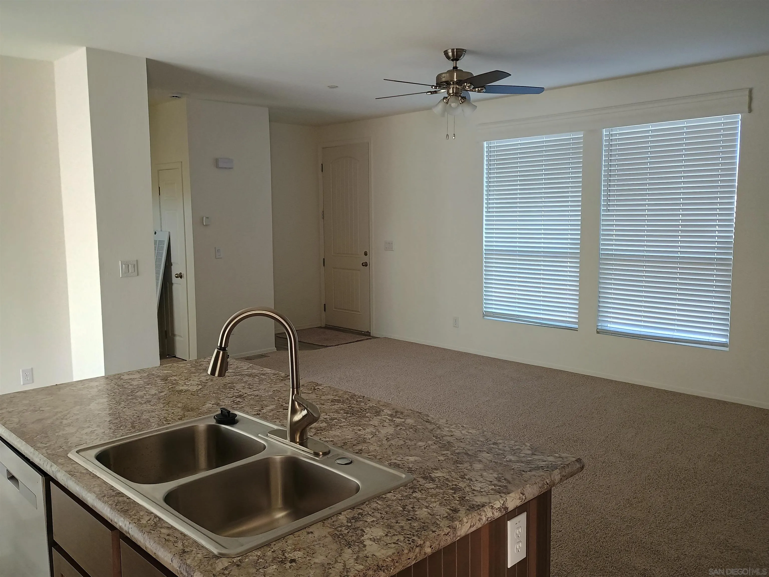 1040 Gillespie Drive Spring Valley, CA 91977 - Photo 2 of 6 a kitchen with a sink a counter cabinets and a window