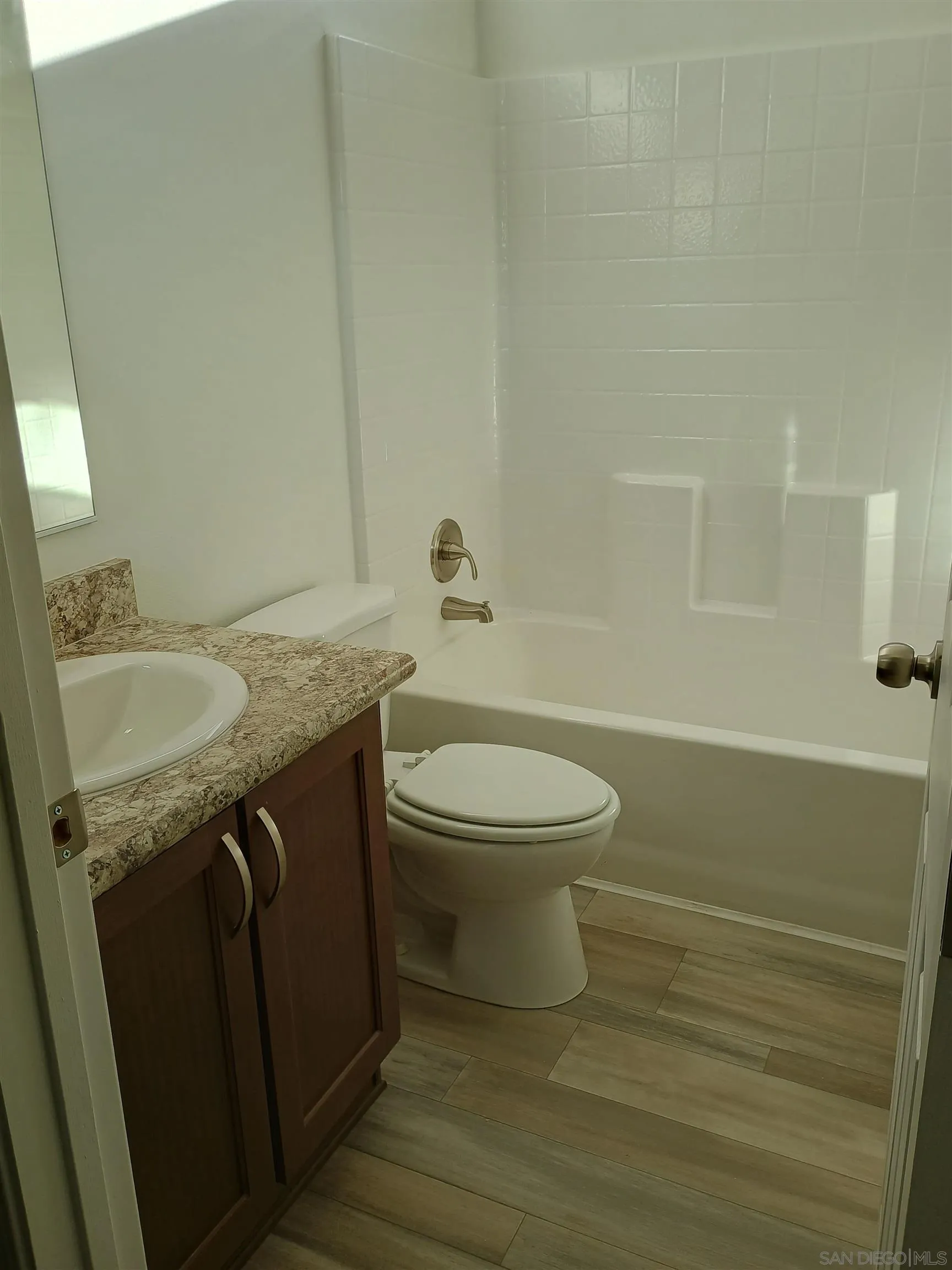 1040 Gillespie Drive Spring Valley, CA 91977 - Photo 6 of 6 a bathroom with a granite countertop sink toilet and shower
