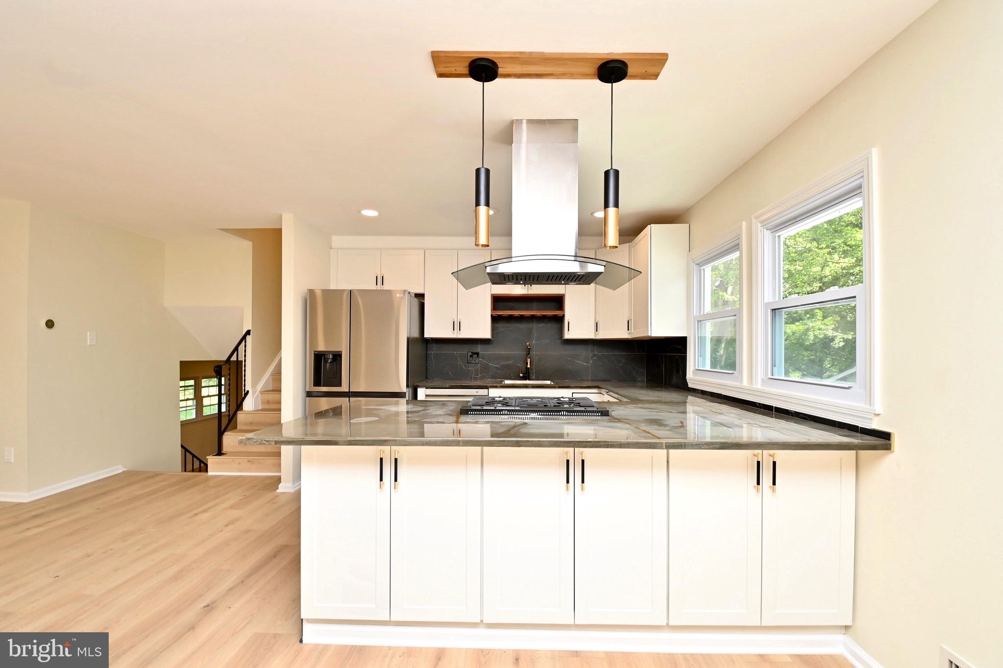 7215 Willow Oak Place Springfield, VA 22153 - Photo 11 of 39 a view of kitchen with kitchen island sink and living room view