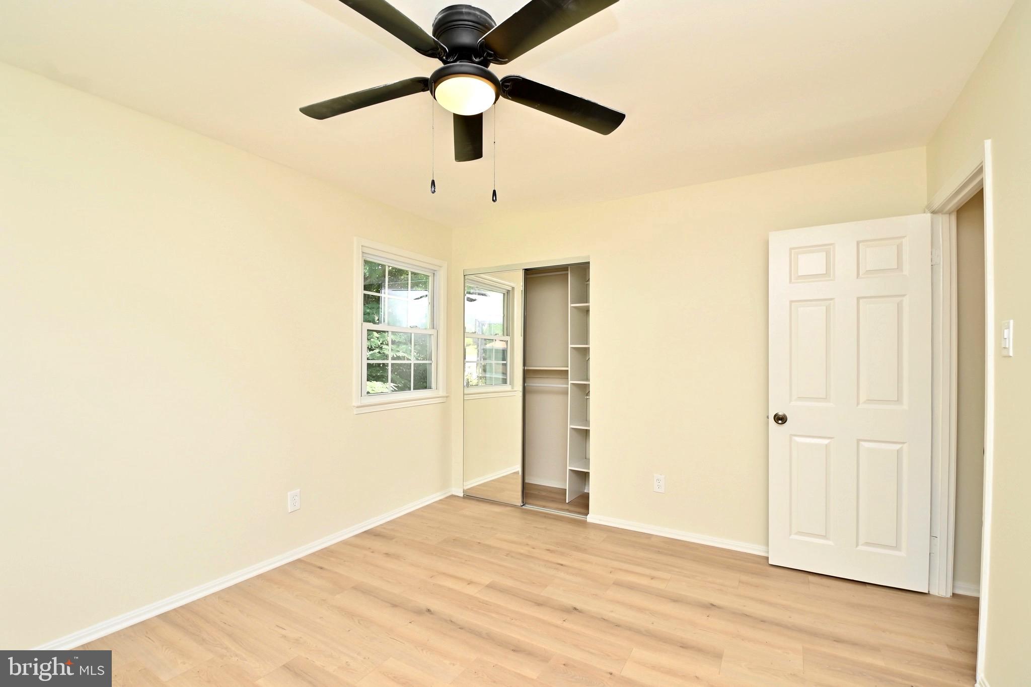7215 Willow Oak Place Springfield, VA 22153 - Photo 17 of 39 an empty room with wooden floor and ceiling fan