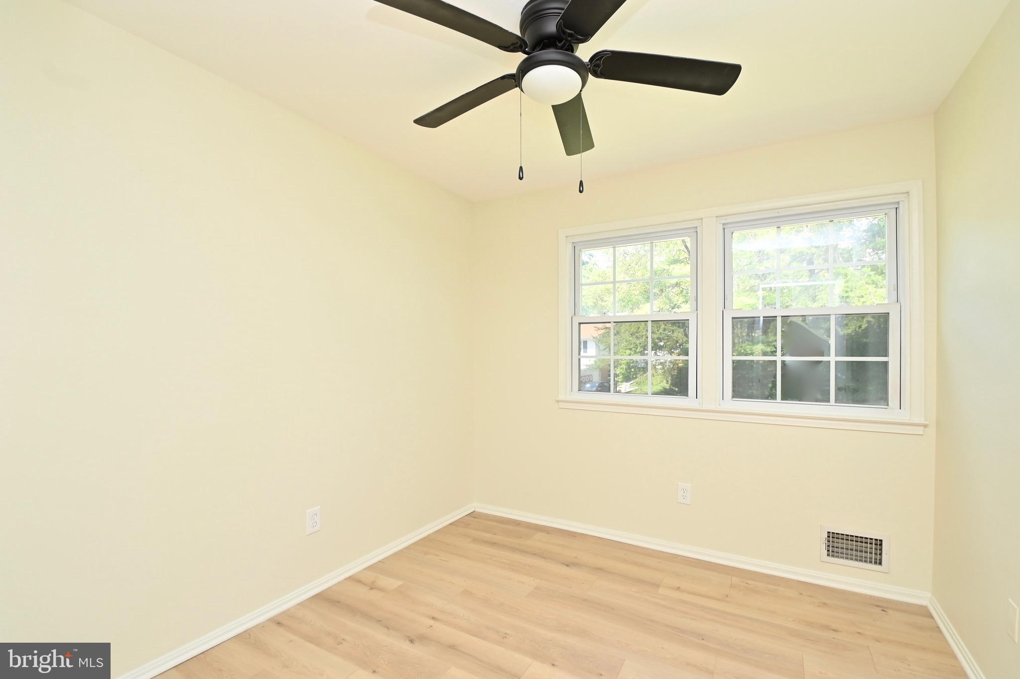 7215 Willow Oak Place Springfield, VA 22153 - Photo 18 of 39 a view of an empty room with a window and wooden floor