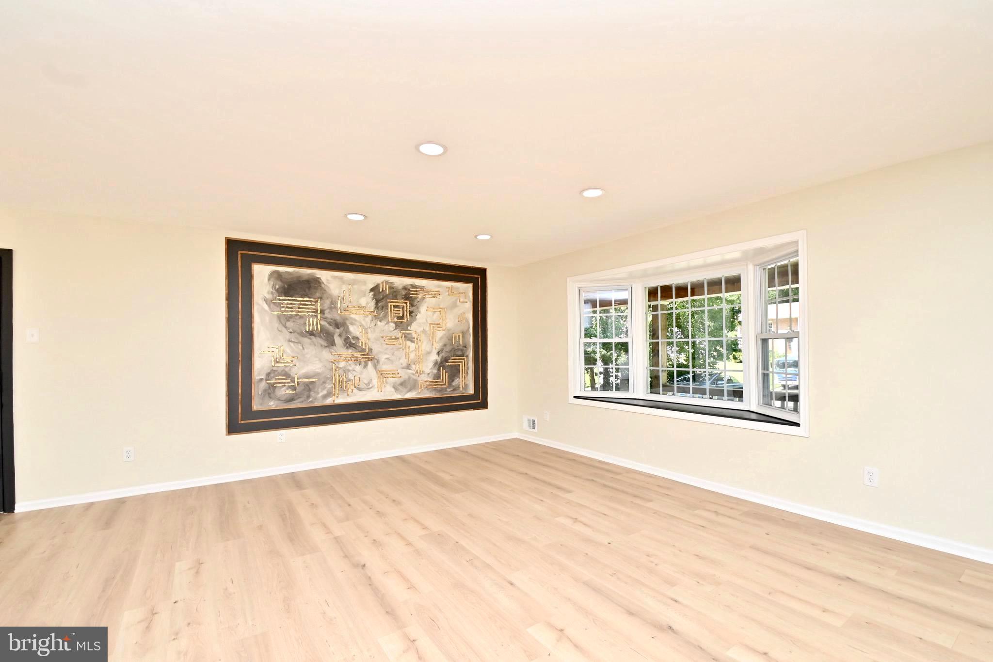 7215 Willow Oak Place Springfield, VA 22153 - Photo 5 of 39 a view of an empty room with wooden floor and a window