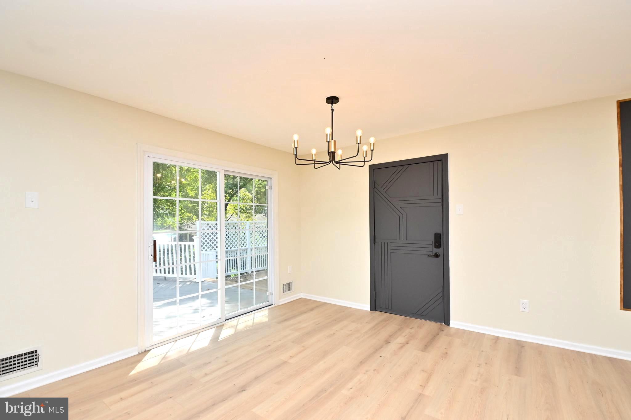 7215 Willow Oak Place Springfield, VA 22153 - Photo 9 of 39 a view of empty room with wooden floor and fan