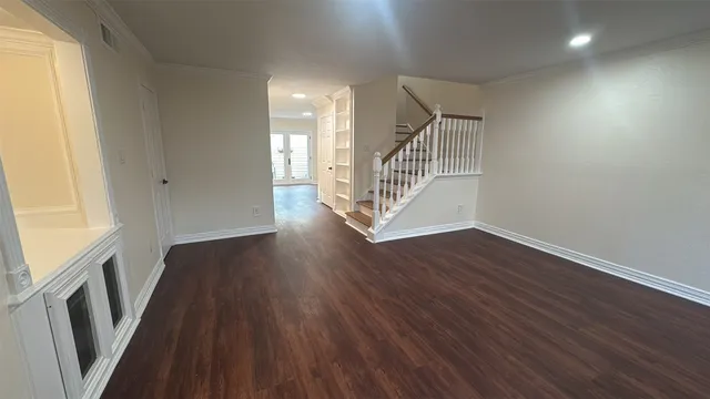 a kitchen with a refrigerator a sink and wooden floor